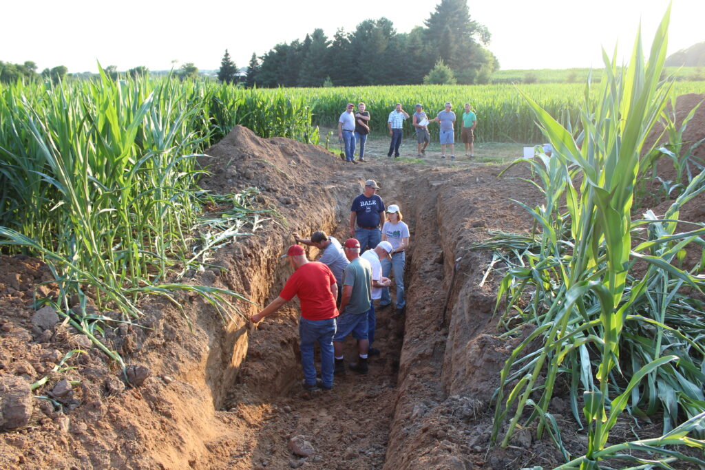 Attendees explore the soil pit